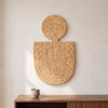 Abstract Mask Design 1 in natural palm leaves, handwoven in Malawi, displayed on a wall