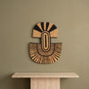 Abstract Mask Design 2 in black patterned palm leaves, handwoven in Malawi, displayed on a wall