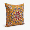 Suzani Pillow - Marigold Rosette, hand embroidered Uzbek suzani pillow seen at an angle